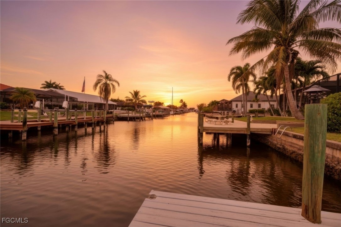 5346 Southwest 10th Avenue Cape Coral, FL 33914 - Photo 2 of 50 a view of a lake with boats and trees in the background