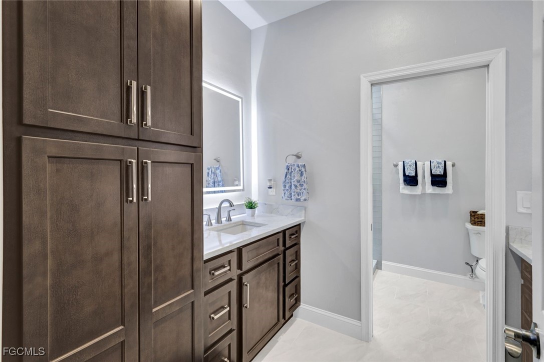 5346 Southwest 10th Avenue Cape Coral, FL 33914 - Photo 23 of 50 a kitchen with cabinets and stainless steel appliances