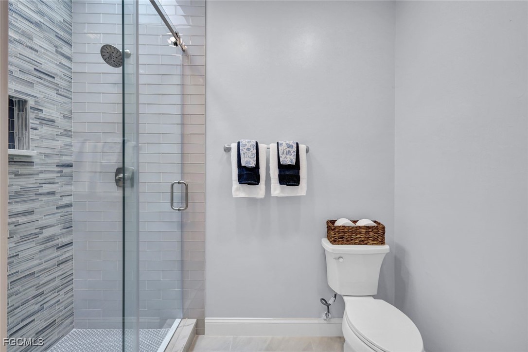 5346 Southwest 10th Avenue Cape Coral, FL 33914 - Photo 24 of 50 a white toilet sitting next to a bathroom sink