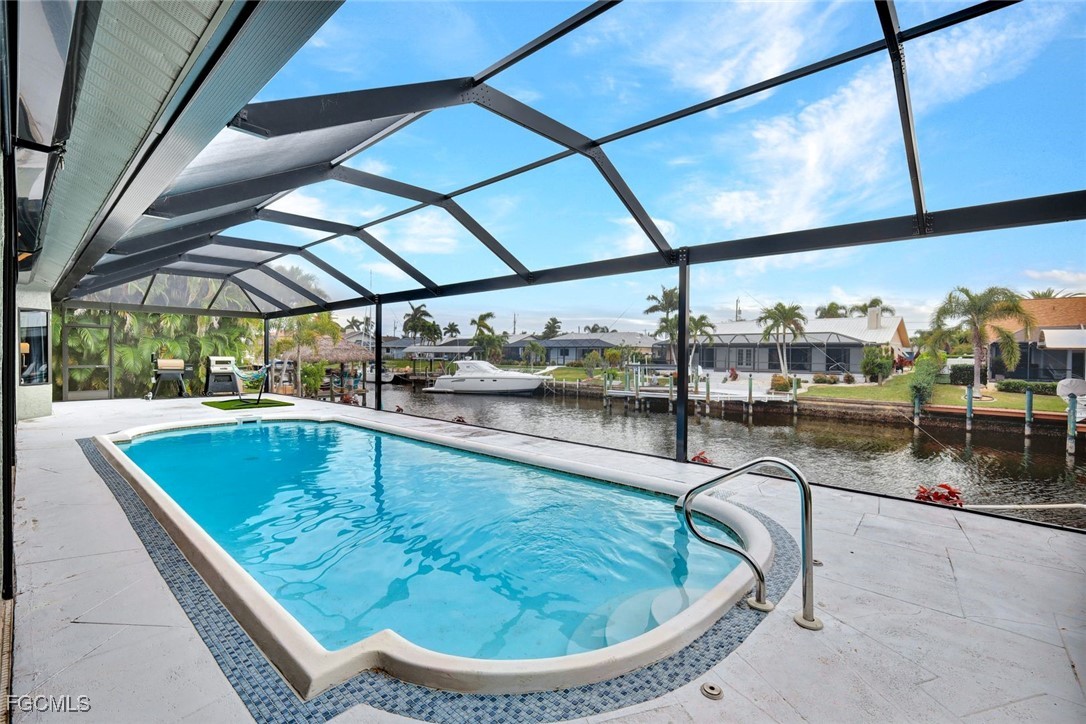 5346 Southwest 10th Avenue Cape Coral, FL 33914 - Photo 31 of 50 a view of a swimming pool with a porch