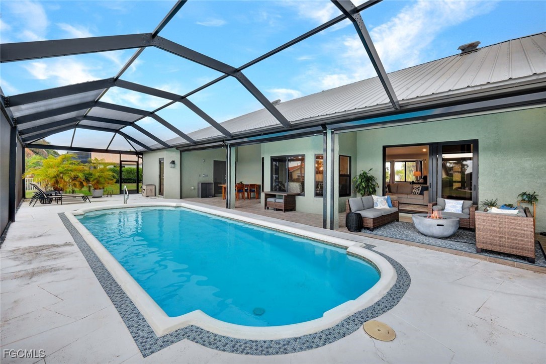 5346 Southwest 10th Avenue Cape Coral, FL 33914 - Photo 33 of 50 a view of a swimming pool with a dining table and chairs