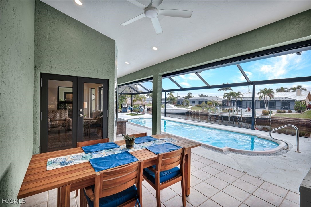 5346 Southwest 10th Avenue Cape Coral, FL 33914 - Photo 36 of 50 a dining room with furniture a chandelier and wooden floor