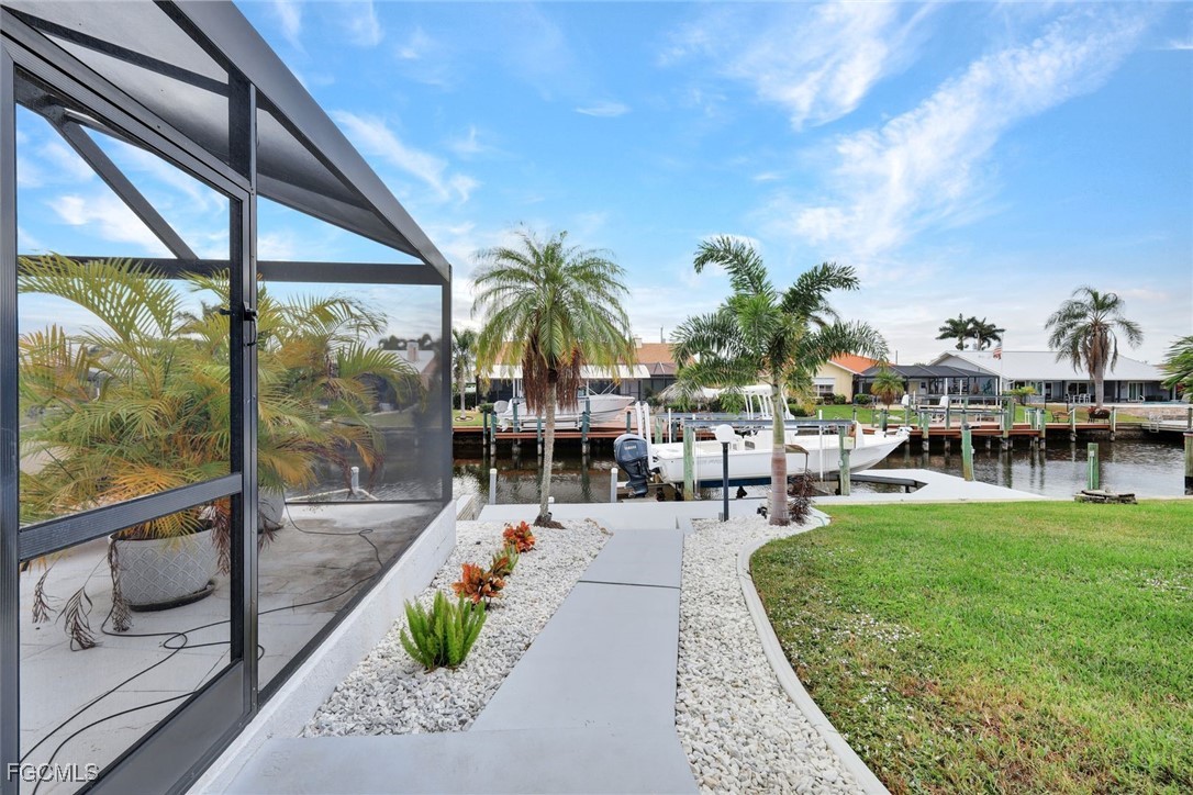 5346 Southwest 10th Avenue Cape Coral, FL 33914 - Photo 37 of 50 a view of a swimming pool with a patio and a garden