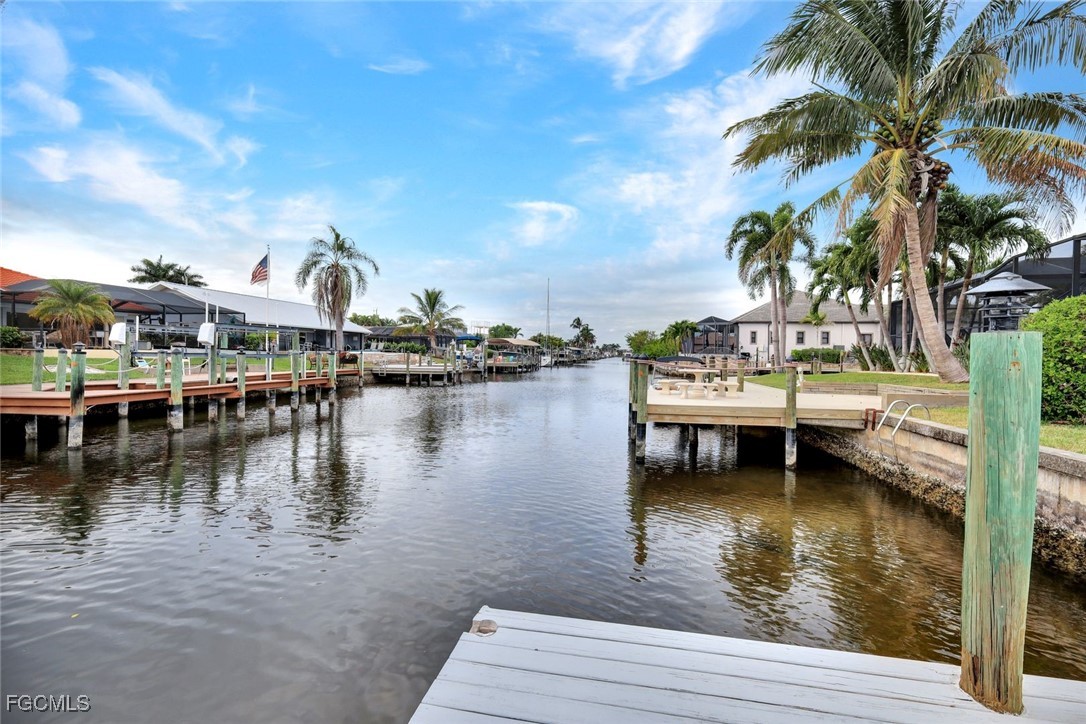 5346 Southwest 10th Avenue Cape Coral, FL 33914 - Photo 41 of 50 a view of a lake with boats and trees in the background