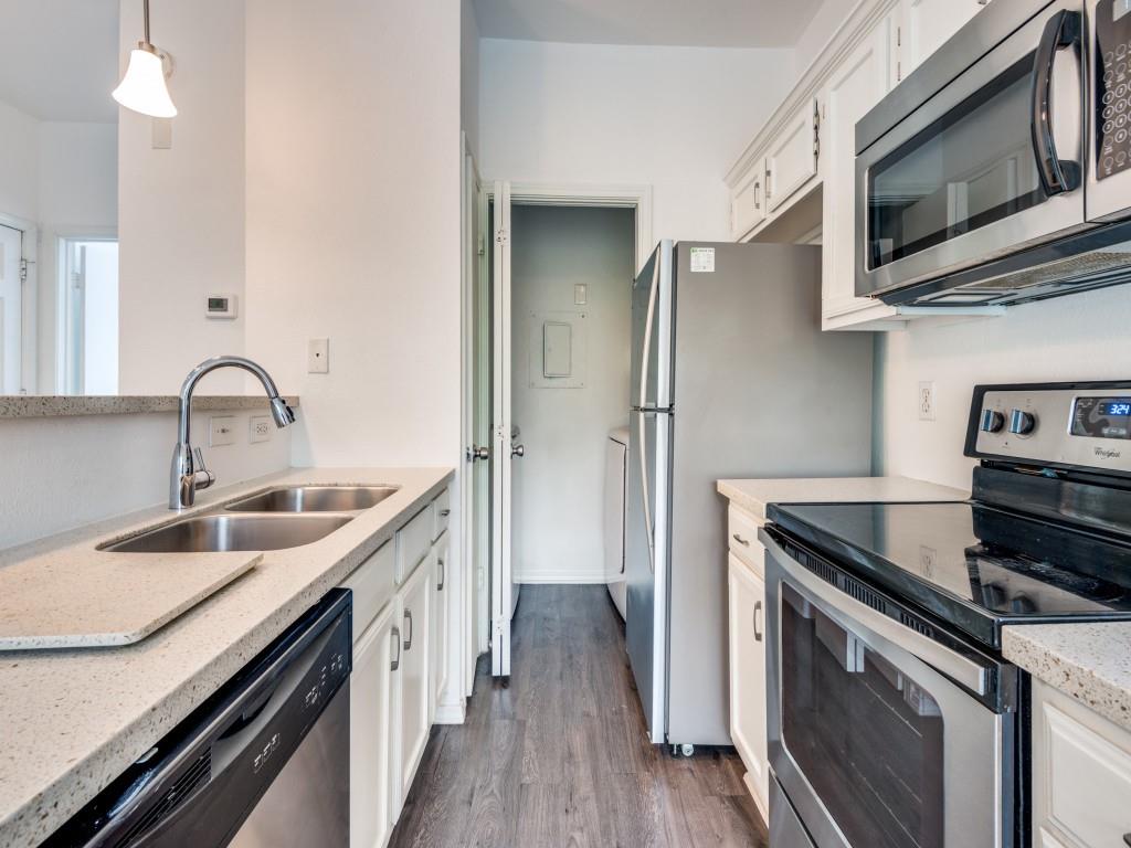 4113 Esters Road, Unit 605 Irving, TX 75038 - Photo 5 of 8 a kitchen with stainless steel appliances granite countertop a sink stove and refrigerator