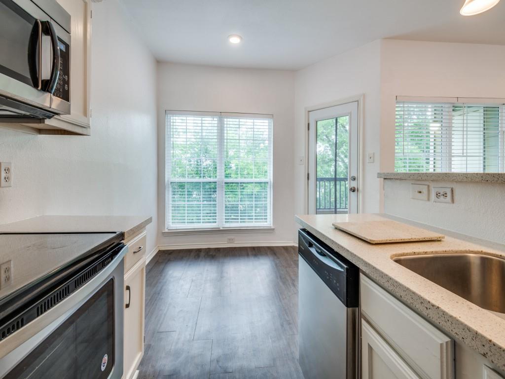 4113 Esters Road, Unit 605 Irving, TX 75038 - Photo 6 of 8 a kitchen that has a sink and a stove