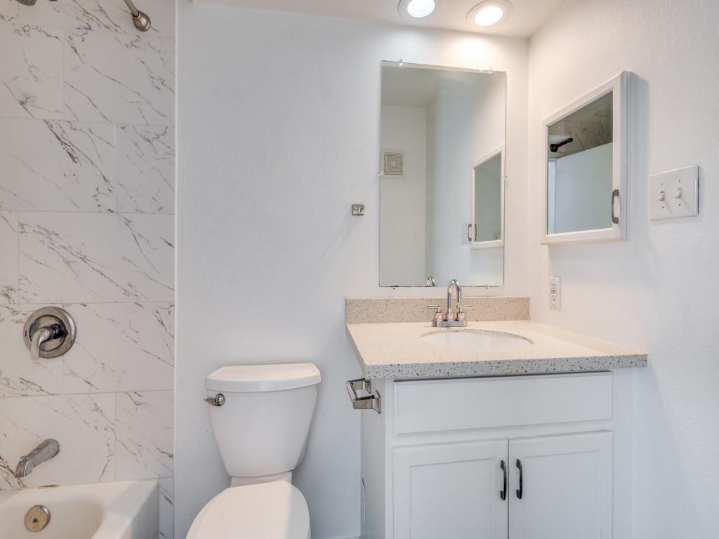 4113 Esters Road, Unit 605 Irving, TX 75038 - Photo 7 of 8 a bathroom with a sink toilet and a mirror