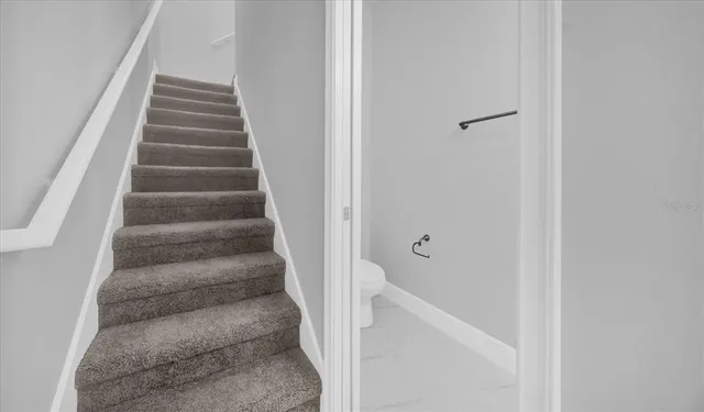 a view of staircase with white walls