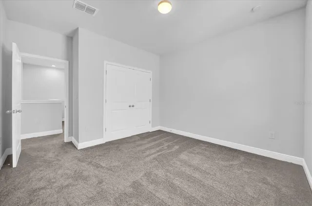 an empty room with closet area