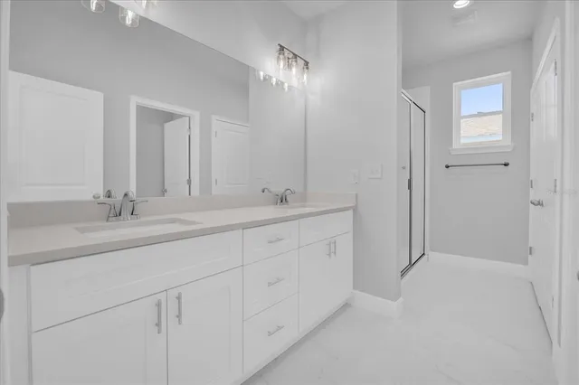 a bathroom with a glass shower door