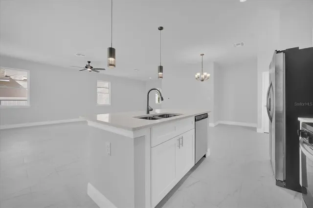 a kitchen with stainless steel appliances a sink and a refrigerator