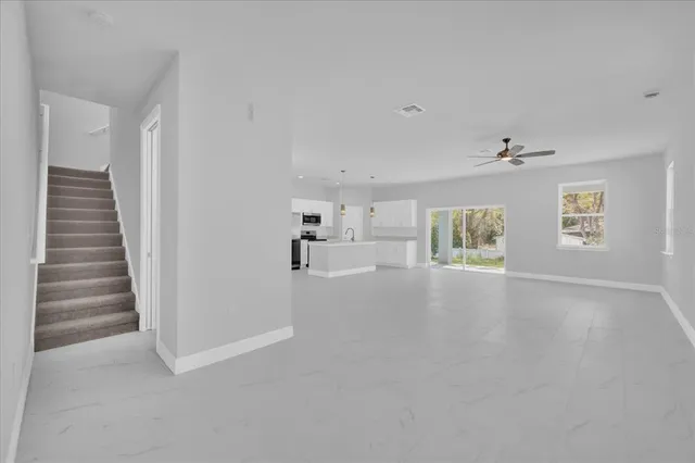a view of hallway with stairs and windows