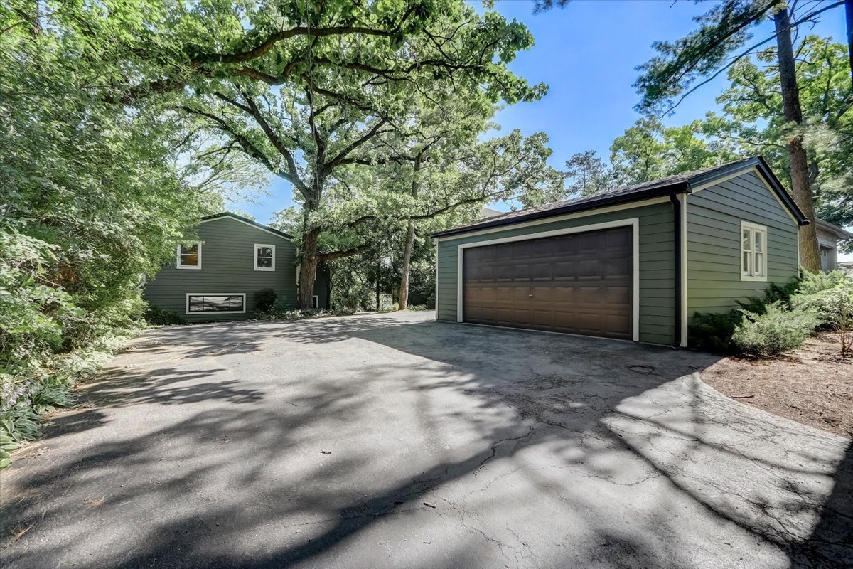 124 Hickory Road Lake In The Hills, IL 60156 - Photo 1 of 49 a front view of a house with a yard and garage