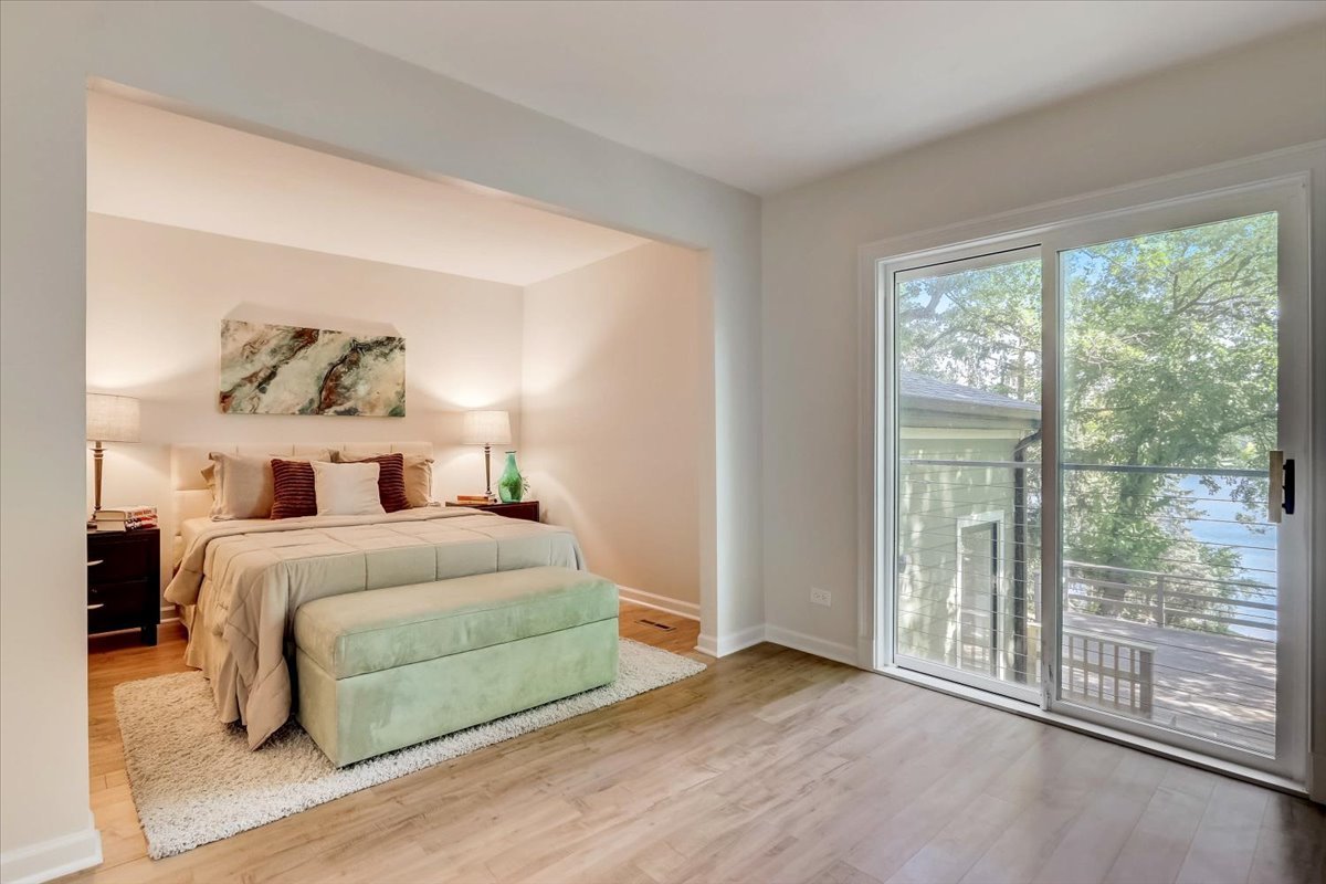 124 Hickory Road Lake In The Hills, IL 60156 - Photo 12 of 49 a bedroom with a large bed and a large window