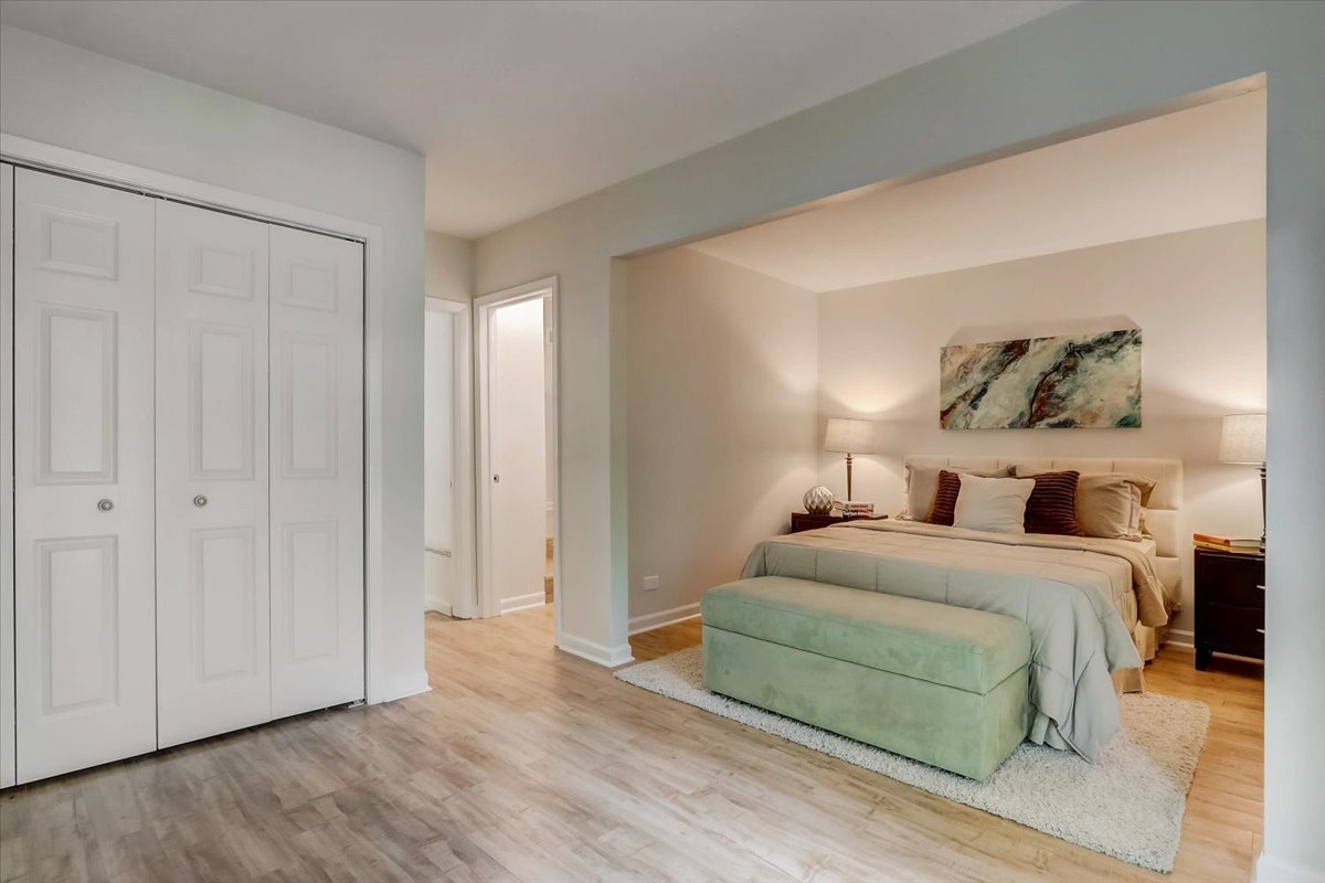 124 Hickory Road Lake In The Hills, IL 60156 - Photo 13 of 49 a bedroom with a bed and a painting