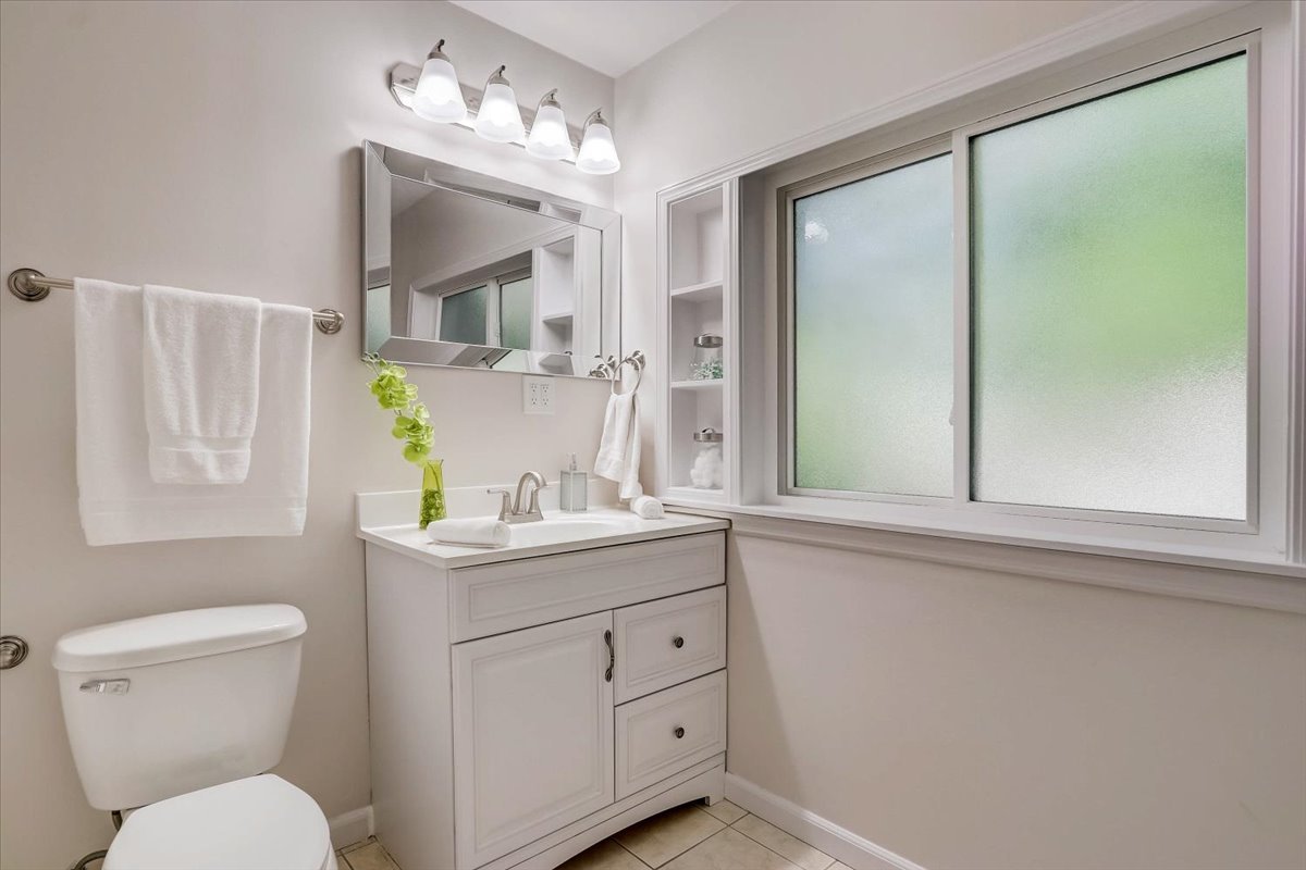 124 Hickory Road Lake In The Hills, IL 60156 - Photo 16 of 49 a bathroom with a granite countertop sink a toilet and mirror
