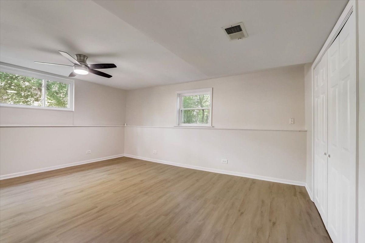 124 Hickory Road Lake In The Hills, IL 60156 - Photo 23 of 49 an empty room with a window and a ceiling fan