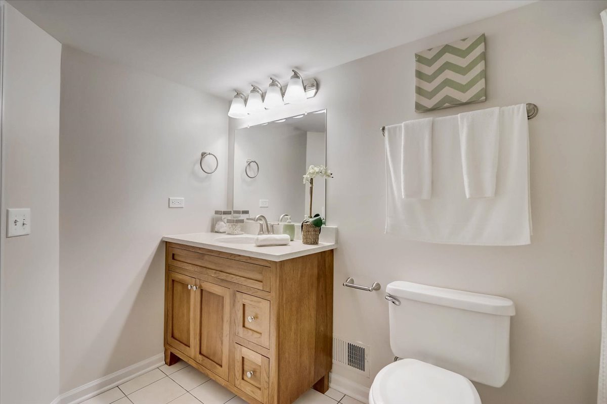 124 Hickory Road Lake In The Hills, IL 60156 - Photo 28 of 49 a bathroom with a granite countertop toilet sink and mirror