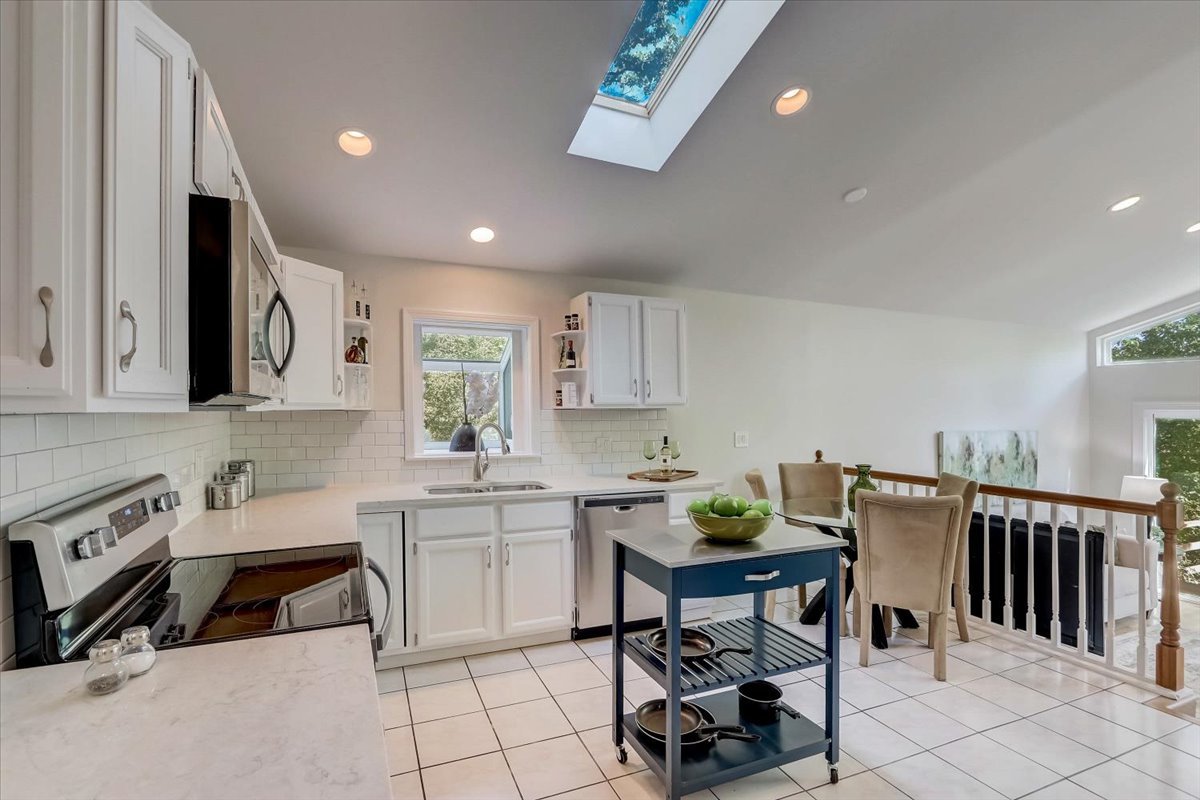 124 Hickory Road Lake In The Hills, IL 60156 - Photo 7 of 49 a kitchen with a table chairs sink and cabinets