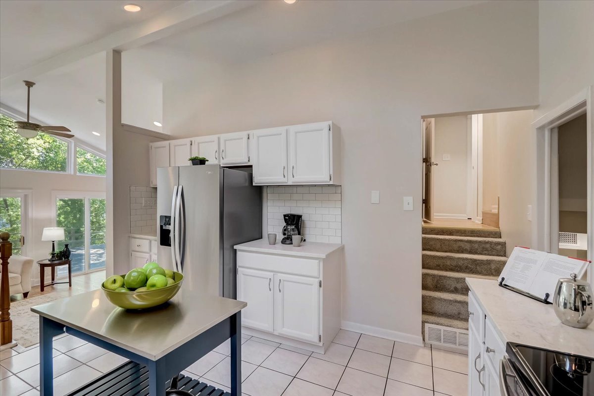 124 Hickory Road Lake In The Hills, IL 60156 - Photo 8 of 49 a kitchen with stainless steel appliances kitchen island granite countertop a table and chairs