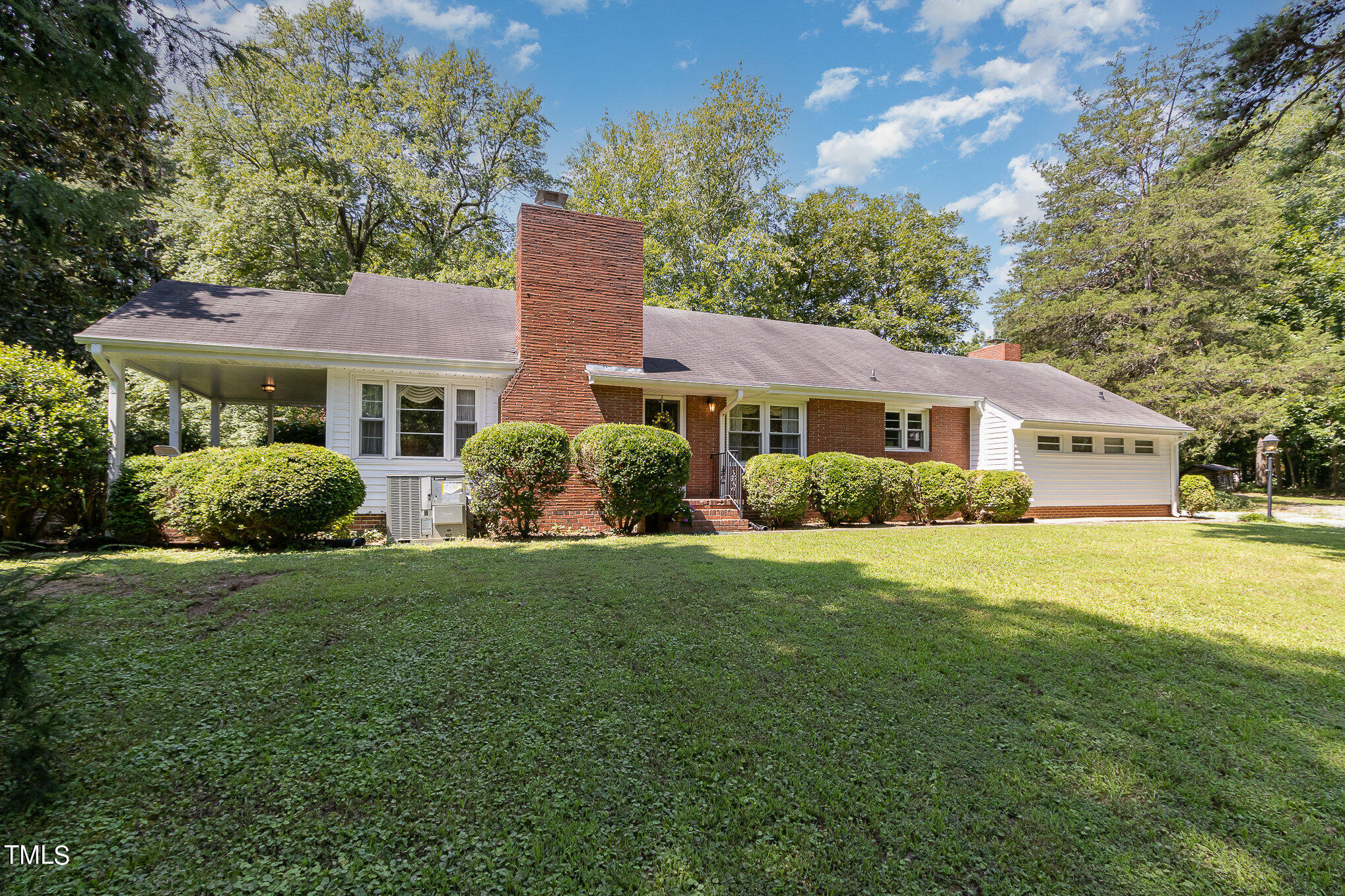 12423 North Roxboro Street Rougemont, NC 27572 - Photo 4 of 30 a front view of a house with a yard and trees