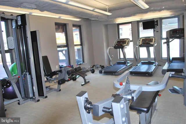 a room with gym equipment and a large window