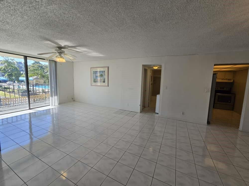 6195 Rock Island Road, Unit 209 Tamarac, FL 33319 - Photo 14 of 40 an empty room with chandelier fan and windows