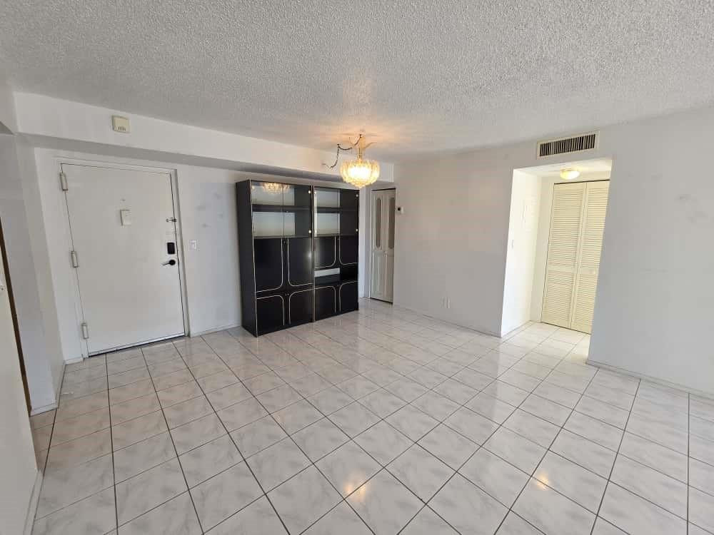6195 Rock Island Road, Unit 209 Tamarac, FL 33319 - Photo 16 of 40 a view of an empty room and chandelier fan