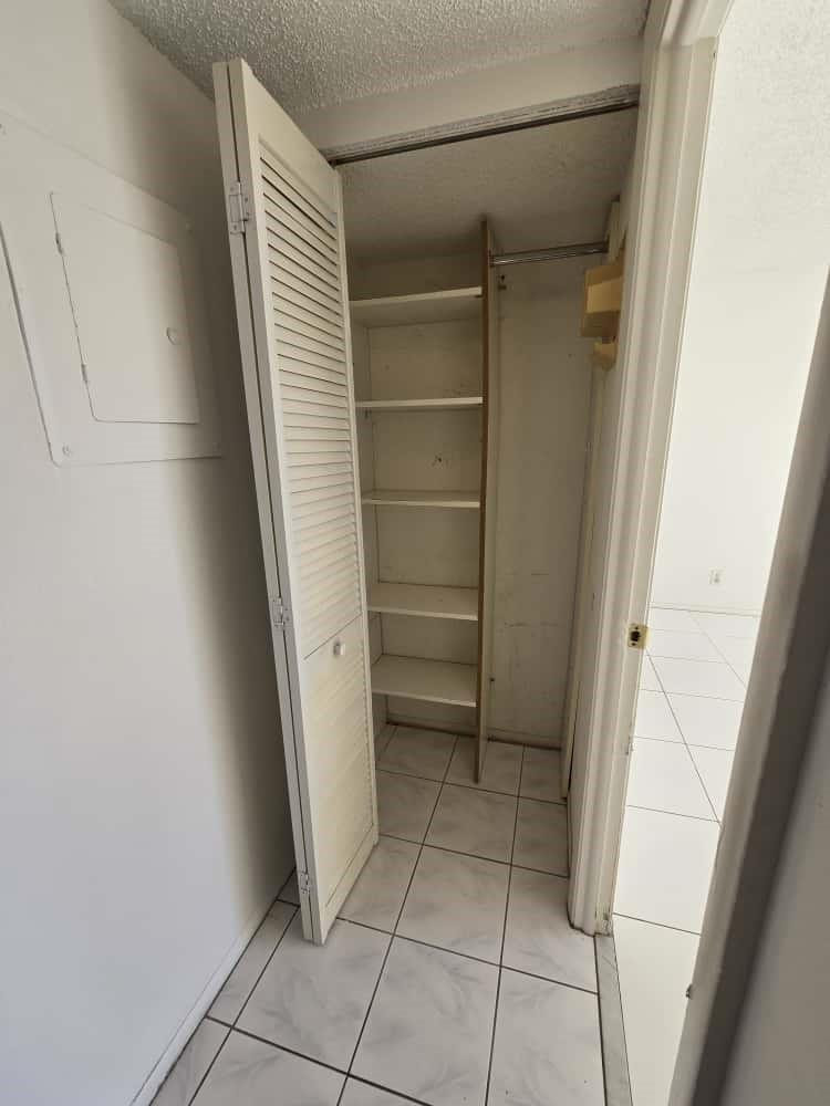 6195 Rock Island Road, Unit 209 Tamarac, FL 33319 - Photo 18 of 40 a view of walk in closet with empty racks