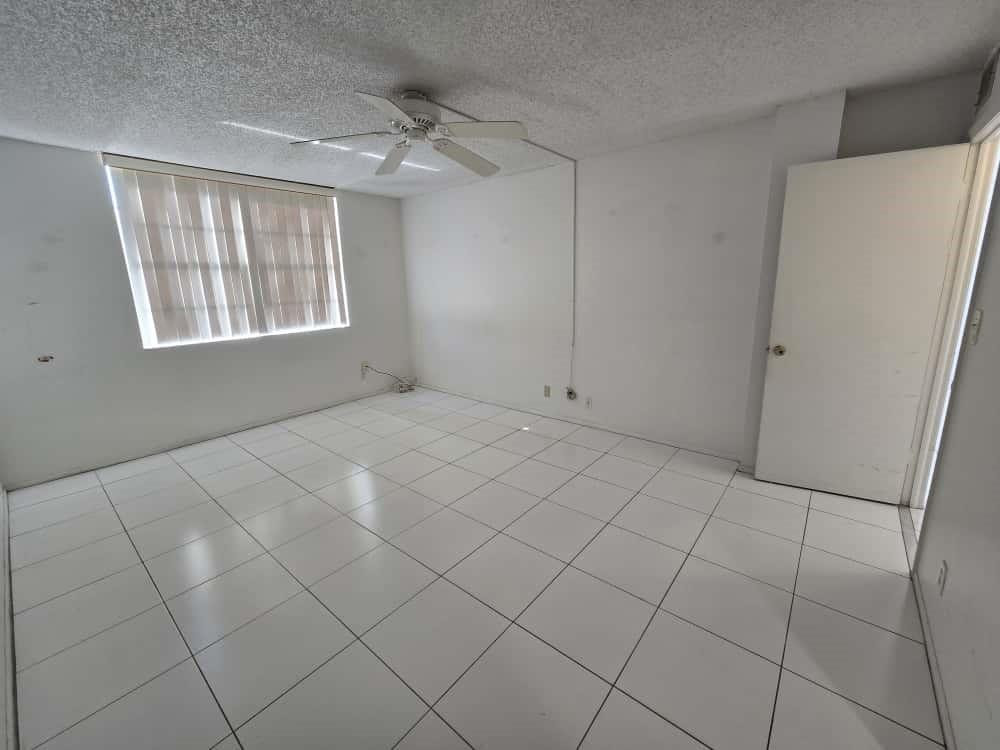 6195 Rock Island Road, Unit 209 Tamarac, FL 33319 - Photo 20 of 40 a view of an empty room with windows