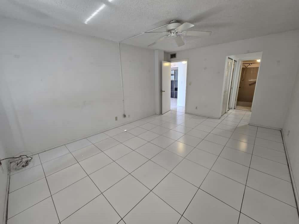 6195 Rock Island Road, Unit 209 Tamarac, FL 33319 - Photo 21 of 40 a view of an empty room and chandelier fan