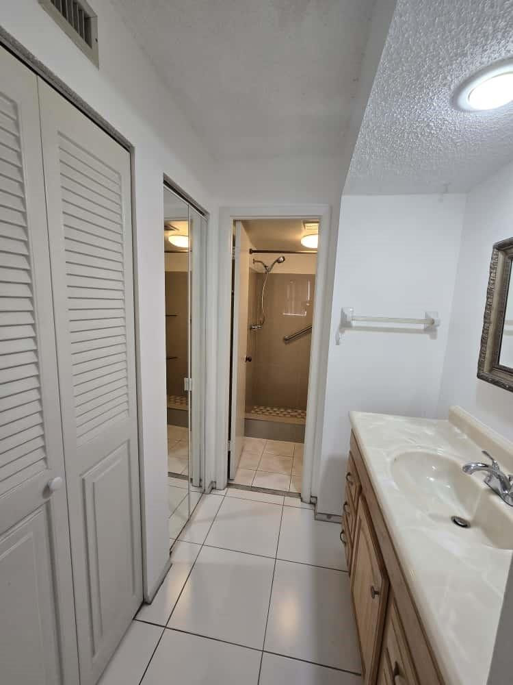 6195 Rock Island Road, Unit 209 Tamarac, FL 33319 - Photo 22 of 40 a bathroom with a sink a toilet and shower