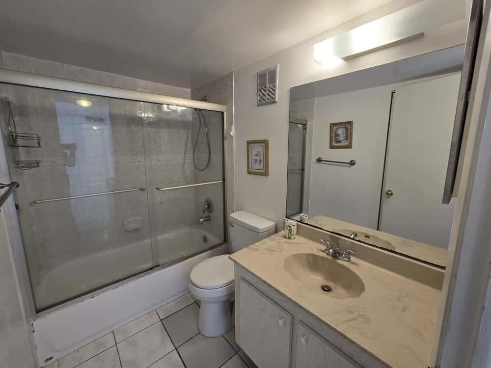 6195 Rock Island Road, Unit 209 Tamarac, FL 33319 - Photo 32 of 40 a bathroom with a sink toilet and shower