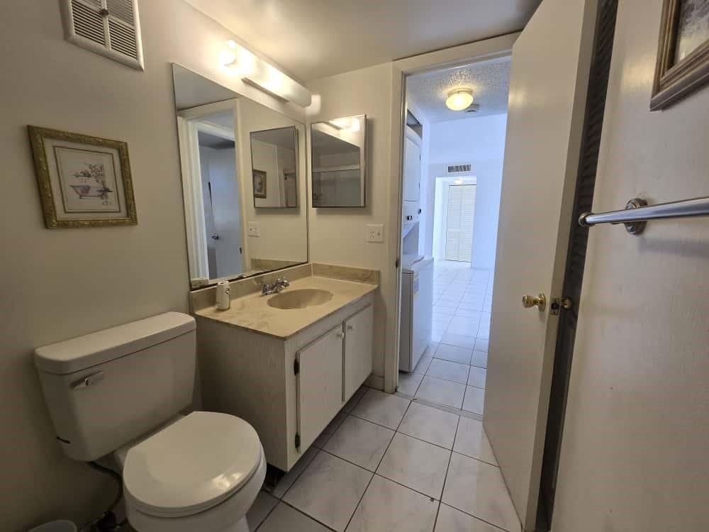 6195 Rock Island Road, Unit 209 Tamarac, FL 33319 - Photo 33 of 40 a bathroom with a sink a toilet and shower