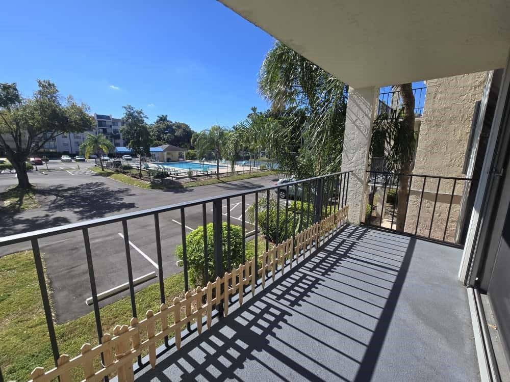 6195 Rock Island Road, Unit 209 Tamarac, FL 33319 - Photo 38 of 40 a view of balcony with wooden floor and fence