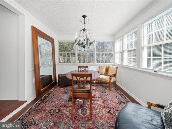 a living room with furniture a rug and a window