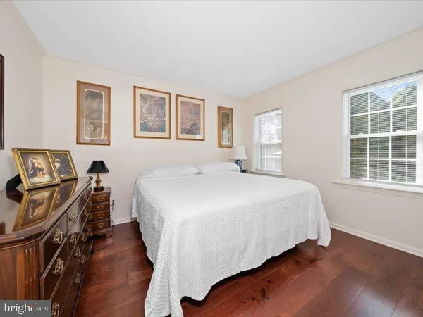 a bedroom with a bed and a wall painting