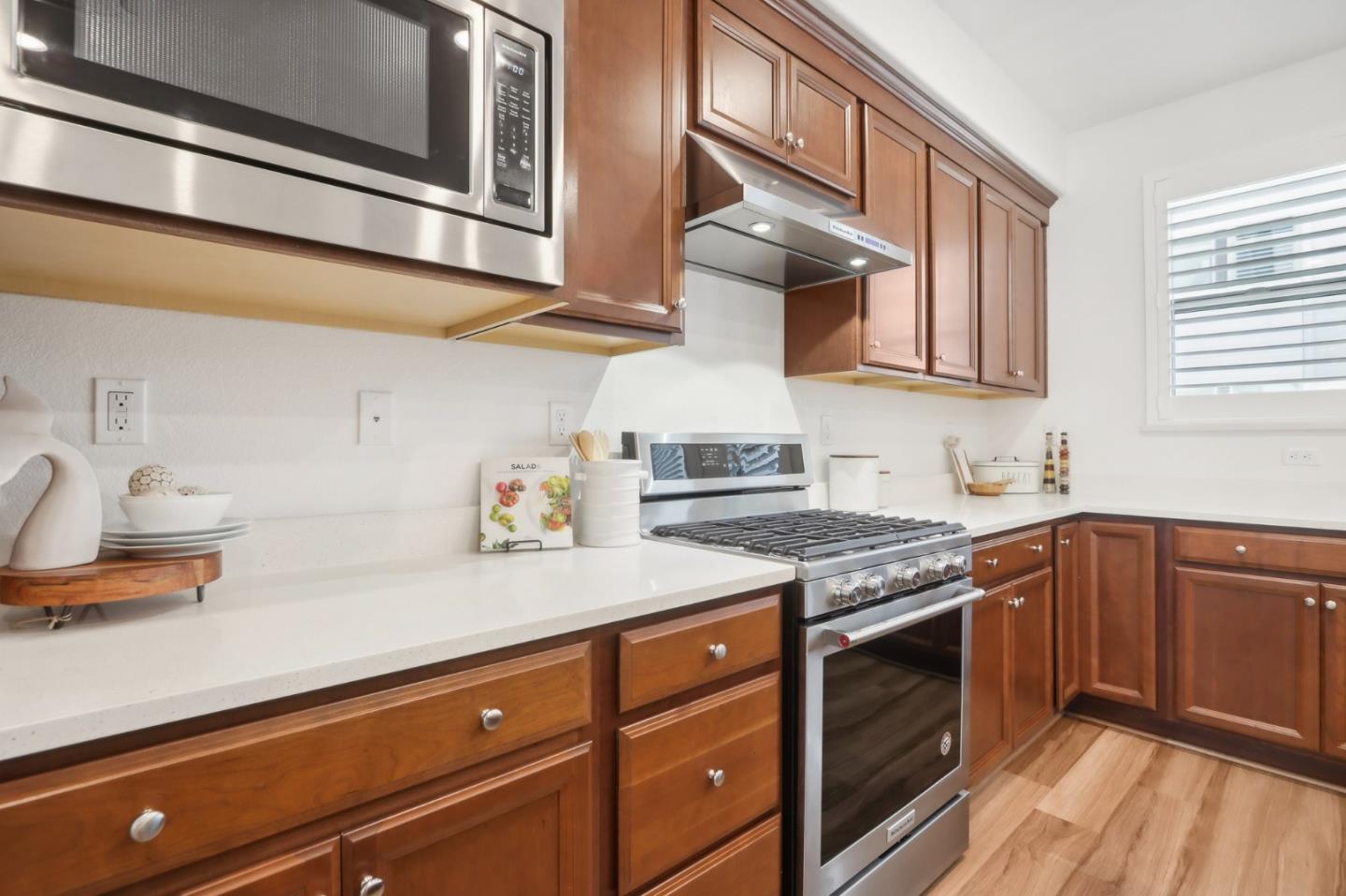 5766 Stealth Loop San Jose, CA 95119 - Photo 18 of 48 a kitchen with stainless steel appliances granite countertop a stove a sink and a microwave