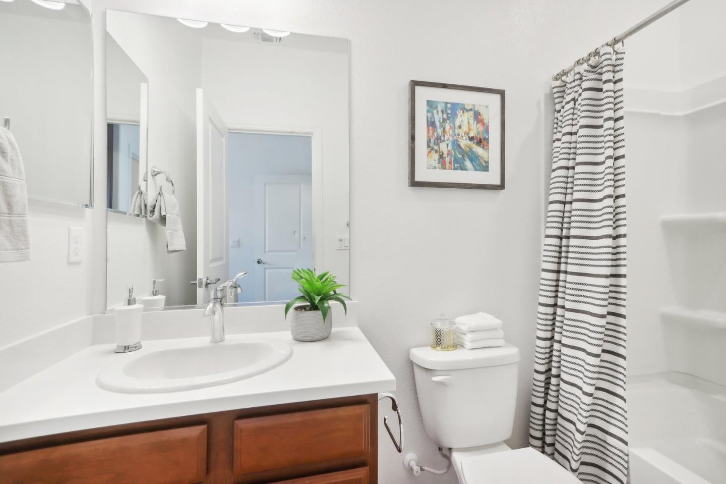 5766 Stealth Loop San Jose, CA 95119 - Photo 23 of 48 a bathroom with a toilet a sink and a mirror
