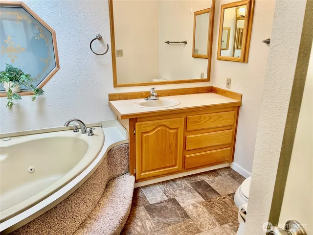 a bathroom with a tub and sink