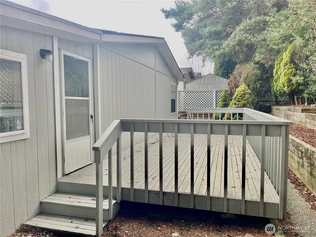 a view of balcony with wooden floor and fence