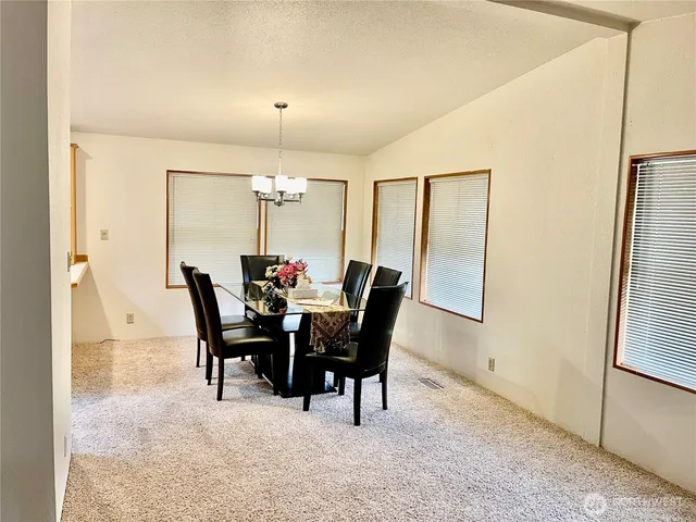 a view of a dining room with furniture and a chandelier