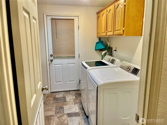 a utility room with a sink a washer and dryer