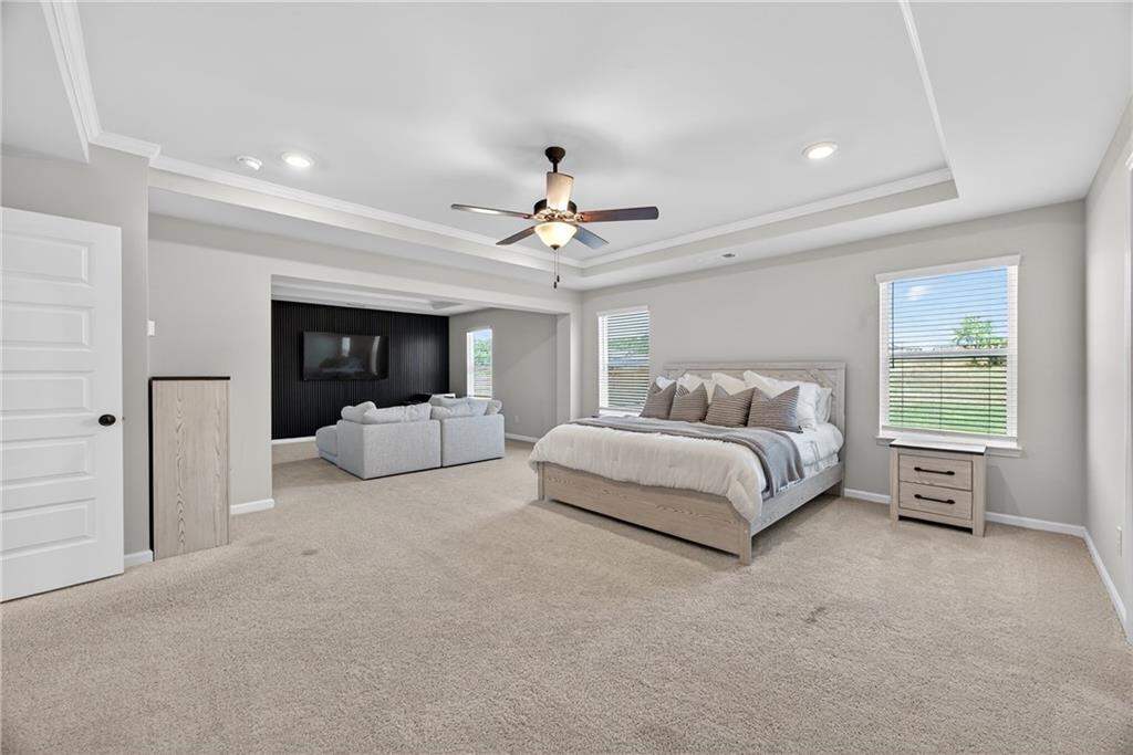 150 Buffalo Trace Stockbridge, GA 30281 - Photo 24 of 35 a spacious bedroom with a large bed and ceiling fan