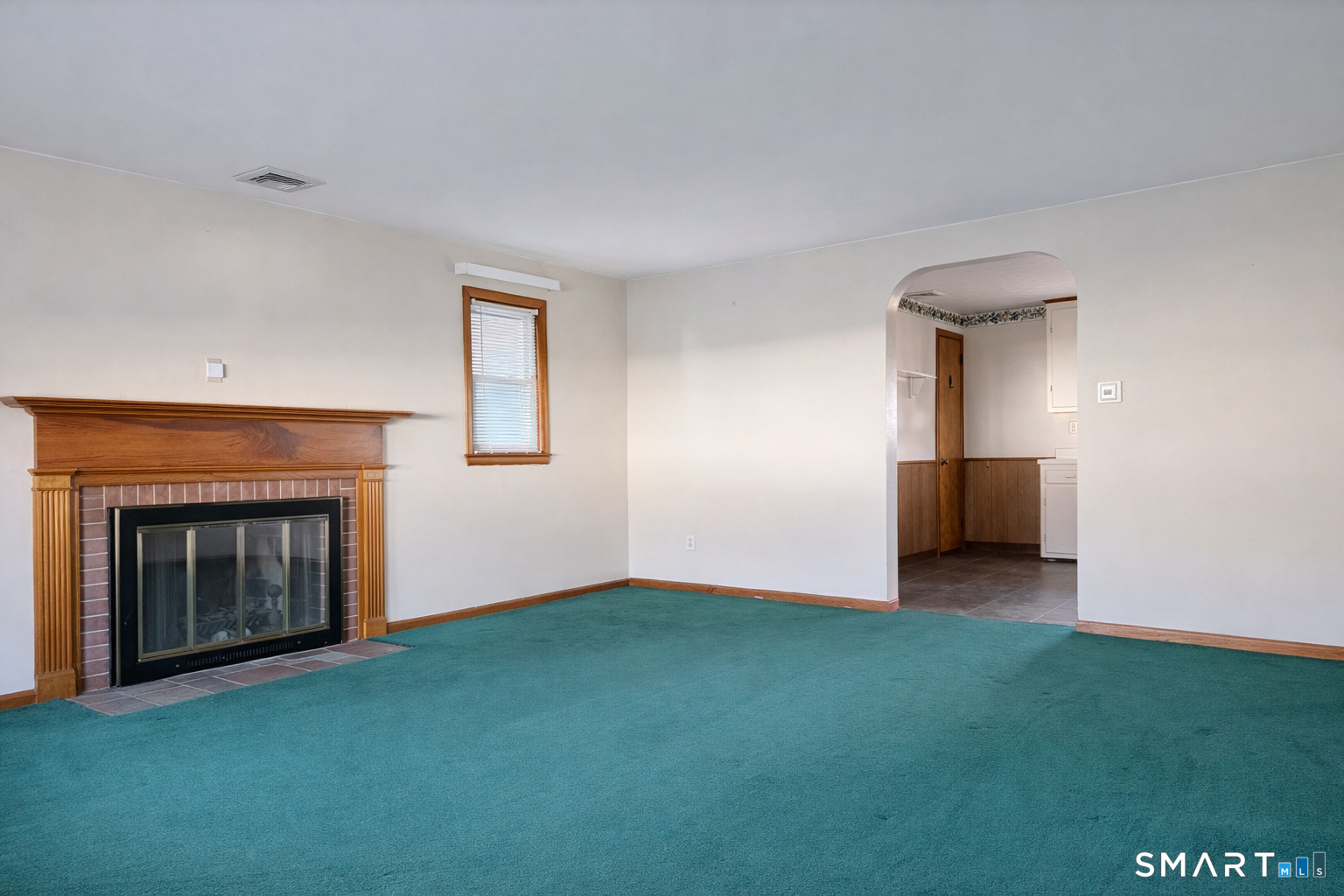 5 Edmund Lane Enfield, CT 06082 - Photo 5 of 11 a view of empty room with window and fireplace