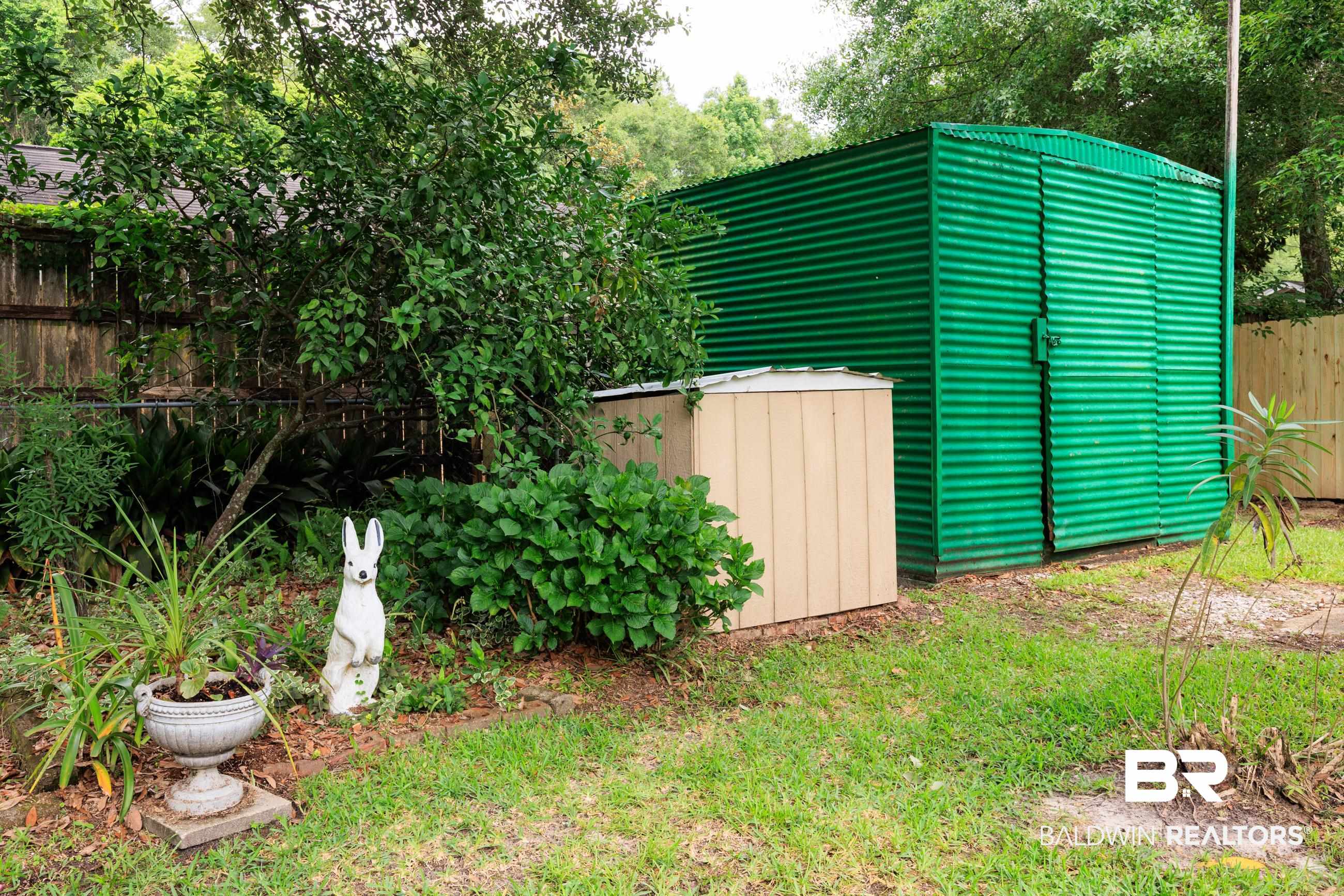1367 Spring Valley Court Mobile, AL 36693 - Photo 18 of 29 Green corrugated metal storage shed with double doors