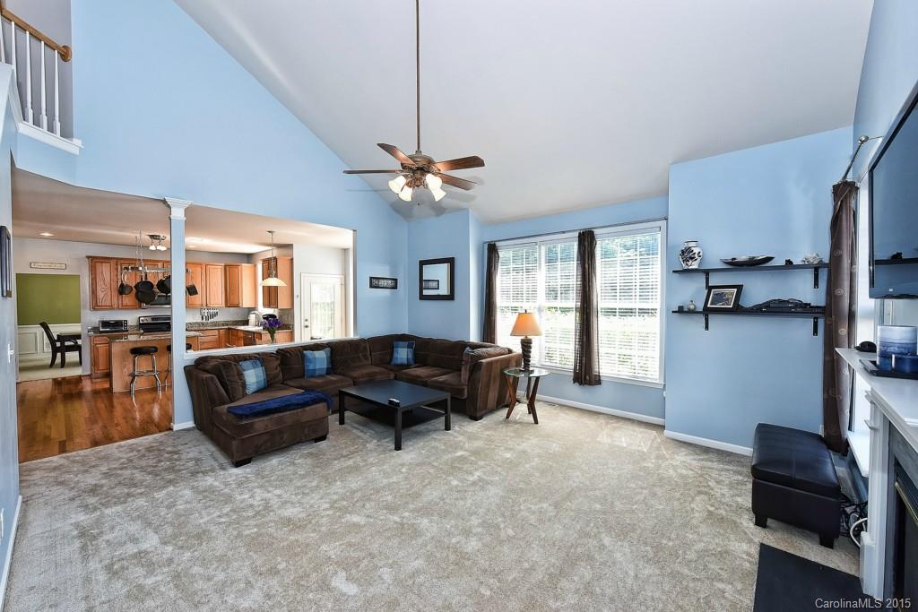 4719 Lapis Court Fort Mill, SC 29708 - Photo 12 of 24 a living room with furniture and a flat screen tv with kitchen view