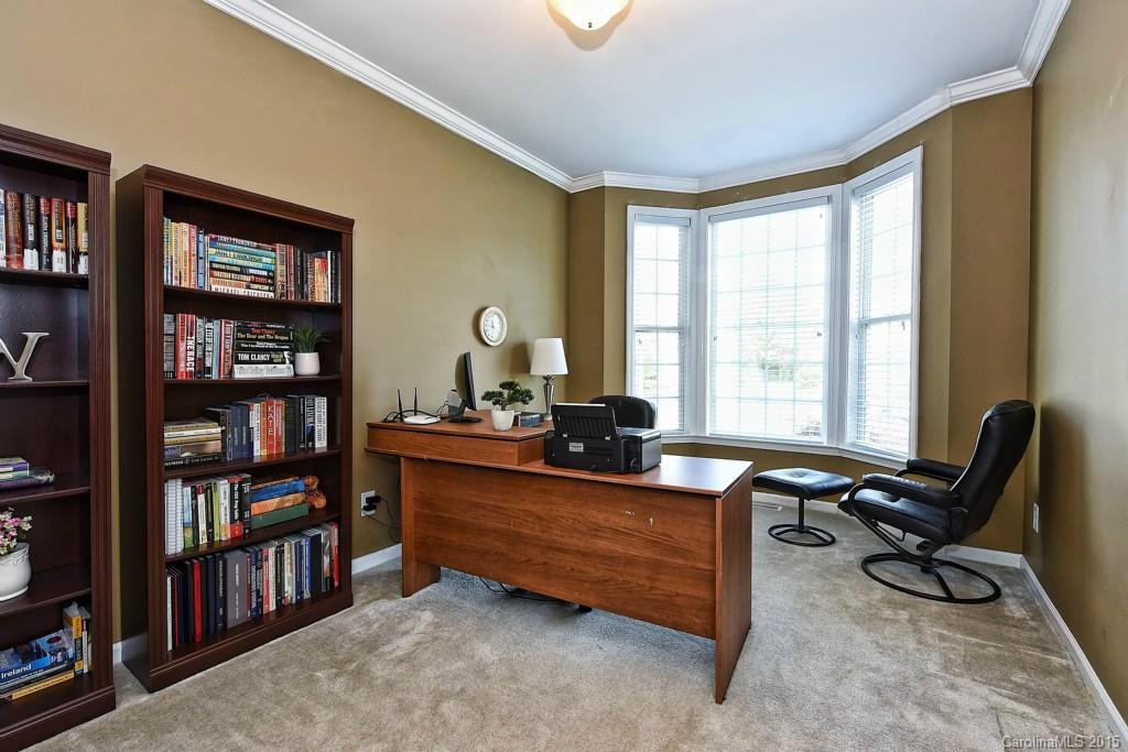 4719 Lapis Court Fort Mill, SC 29708 - Photo 14 of 24 a view of a workspace with furniture and a bookshelf