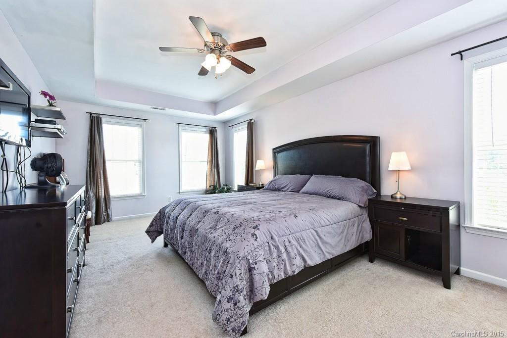 4719 Lapis Court Fort Mill, SC 29708 - Photo 16 of 24 a bedroom with a bed and a chandelier