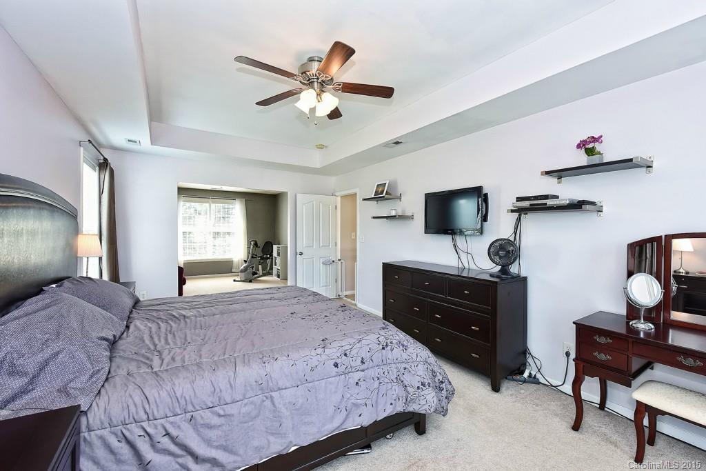 4719 Lapis Court Fort Mill, SC 29708 - Photo 17 of 24 a bedroom with a bed and a flat screen tv
